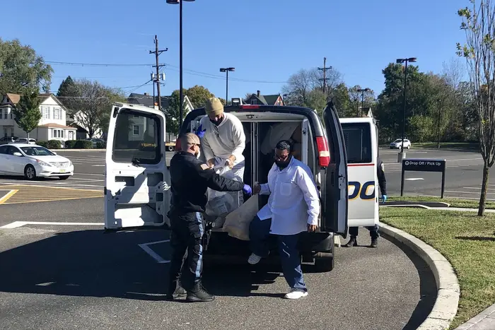 Formerly incarcerated people step out of a van and are released from New Jersey custody at the Pennsauken Transit Center.